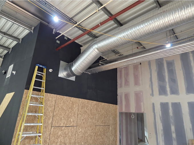 Ventilation ductwork installation in a commercial building under construction
